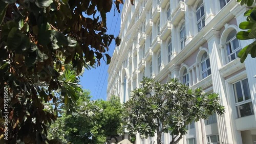 Expensive luxury hotel white building entrance in the middle flowers beautiful large hall golden photo