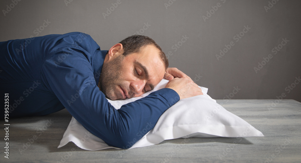 Obraz premium Tired caucasian man sleep at workplace.