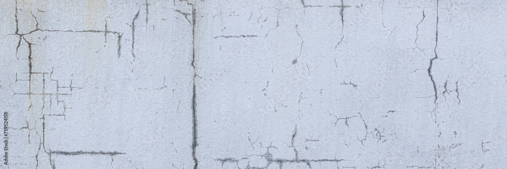 Old wall with cracked plaster. Weathered rough surface. Wide panoramic texture for background and design.