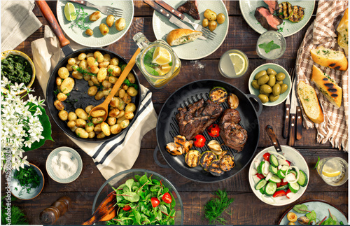 Different food on a wooden table. Baked meat and vegetables created with AI.
