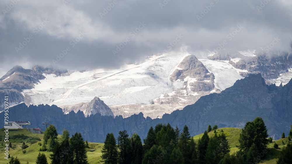 Amazing landscape to the Marmolada and its glaciers during summer time. Melting of glaciers due to global warming. It is the highest mountain of the Dolomites. Italian alps