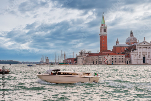 Water taxi in front of the island of San Giorgio Maggiore in the background in the Venice lagoon in Veneto, Italy