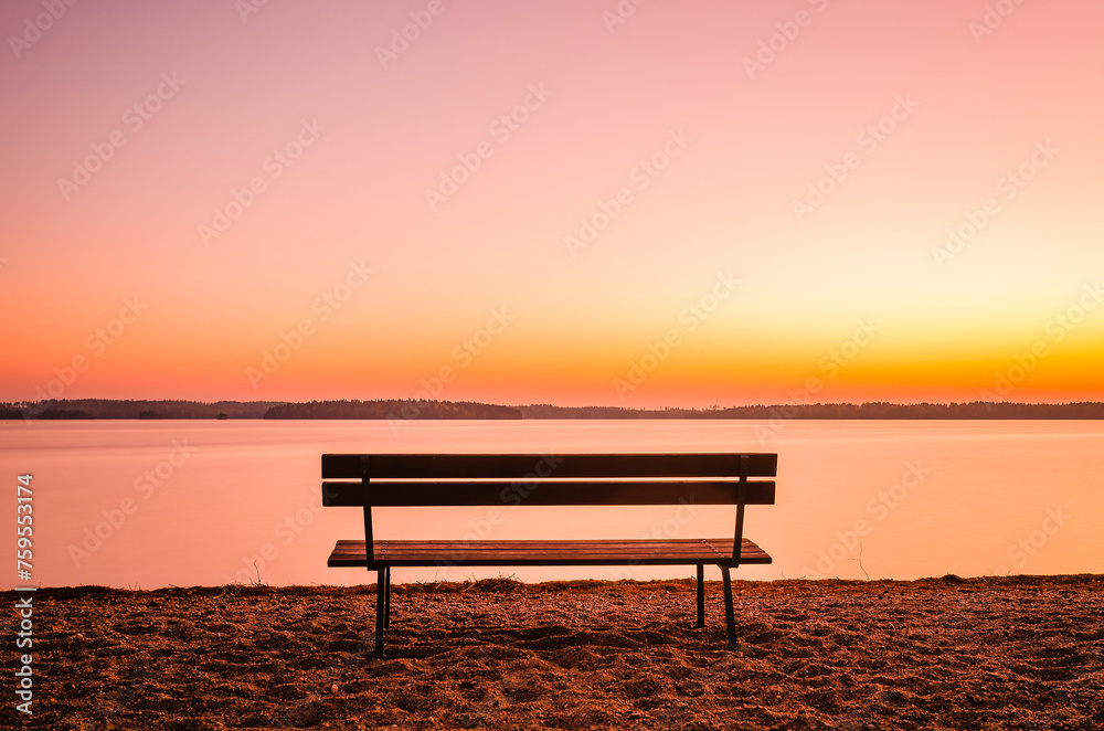 Solitary Bench Overlooking a Tranquil Lake During a Sunset in Sweden