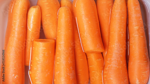 Carrot in plastic container, closeup. Healthy food background.