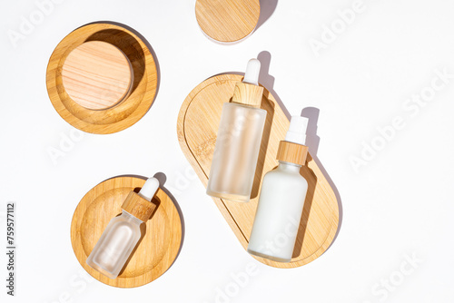 Eco friendly refillable cosmetics packaging on white background. Skin care unbranded bottles and jars. top view