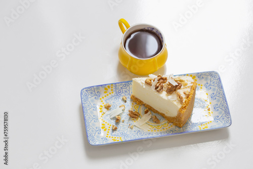 yellow cup of coffee with cheesecake on white table