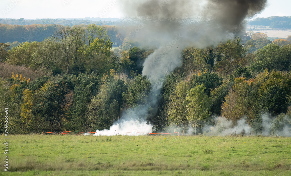 white smoke rising after an artillery shell impact
