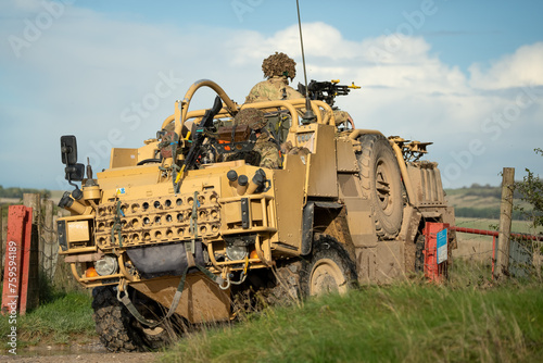 close-up of a British army Supacat Jackal 4x4 rapid assault, fire support and reconnaissance vehicle, in action on a military exercise, Wilts UK photo