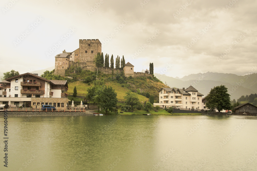 Castle reflected in the water of the lake. Laudegg Castle (German: Burg Laudegg). Ladis, Austria