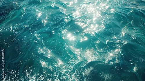 Blue green surface of the ocean with light refracting.