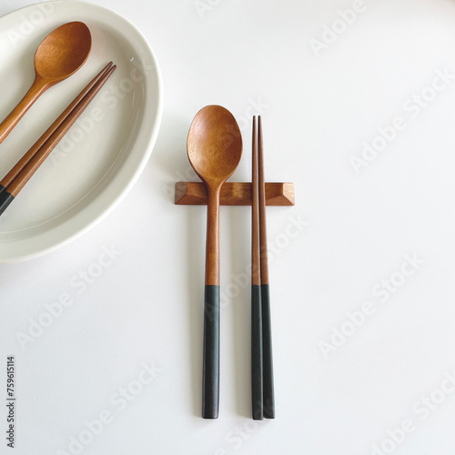 wooden spoon and chopstick set on the white table.