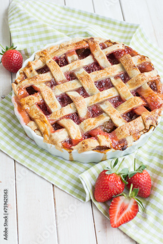 home made pie with rhubarb and strawberry on white background close up selective focus