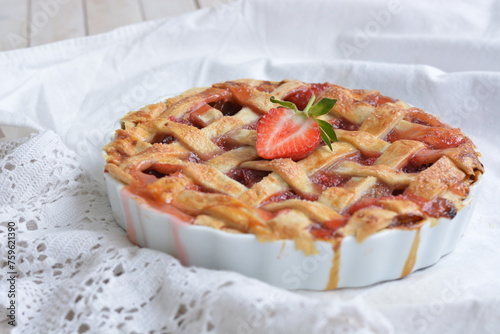 home made pie with rhubarb and strawberry on white background close up selective focus