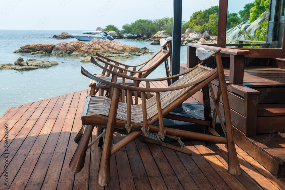 Wooden sunbed at resort patio by sea, Ko Man Klang, Rayong