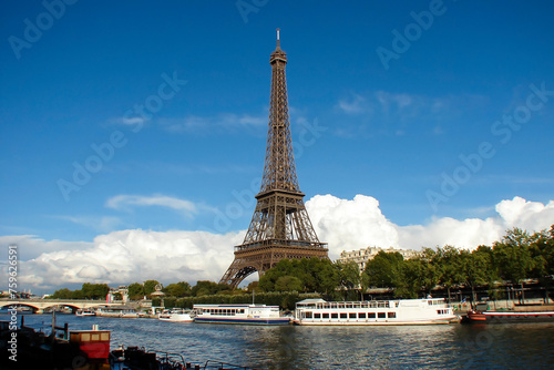 view of the Eiffel Tower and the Seine Rver  Paris  France  white pleasure boats at a pier