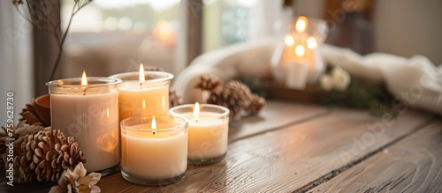 Scented candles displayed on a wooden table indoors