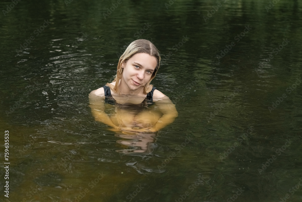 Portrait of a young beautiful blonde girl by the river. Portrait of a young beautiful blonde girl by the river.