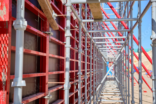 Vertical panel formwork, push-pull jacks and scaffoldings of reinforced concrete walls under construction. Structures for cast in place reinforced concrete