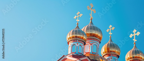 Big Golden Domes with cross of Orthodox Church. Metal Dome of Orthodox Church top on a sky background with copy space. photo