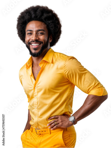 A man with an afro and wearing a yellow shirt and pants stands with his hands on his hips, smiling at the camera.