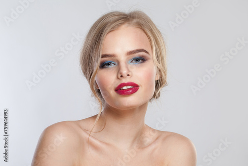 Glamorous young fashion woman with healthy blonde hair and make-up on white background