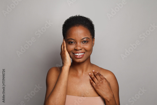Good-looking healthy lady with dark clean fresh skin on white background. Advertising, product placement, medicine and treatment concept