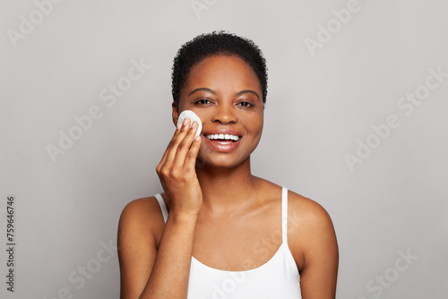 Pretty healthy woman with fresh skin holding white cotton pad in her hand. Medicine, treatment and skin cleansing concept