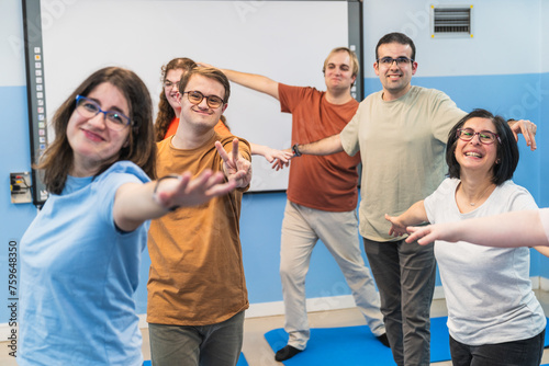 Yoga students with Down Syndrome extend open arms in a gesture of inclusive joy.