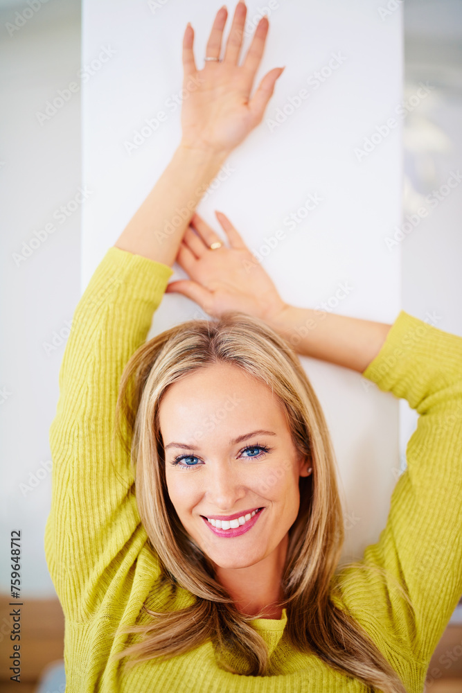 Fototapeta premium Leaning against a wall, portrait and home with woman, relax and resting with comfort and confidence. Face, person and apartment with girl and calm with weekend break, smile or vacation with happiness