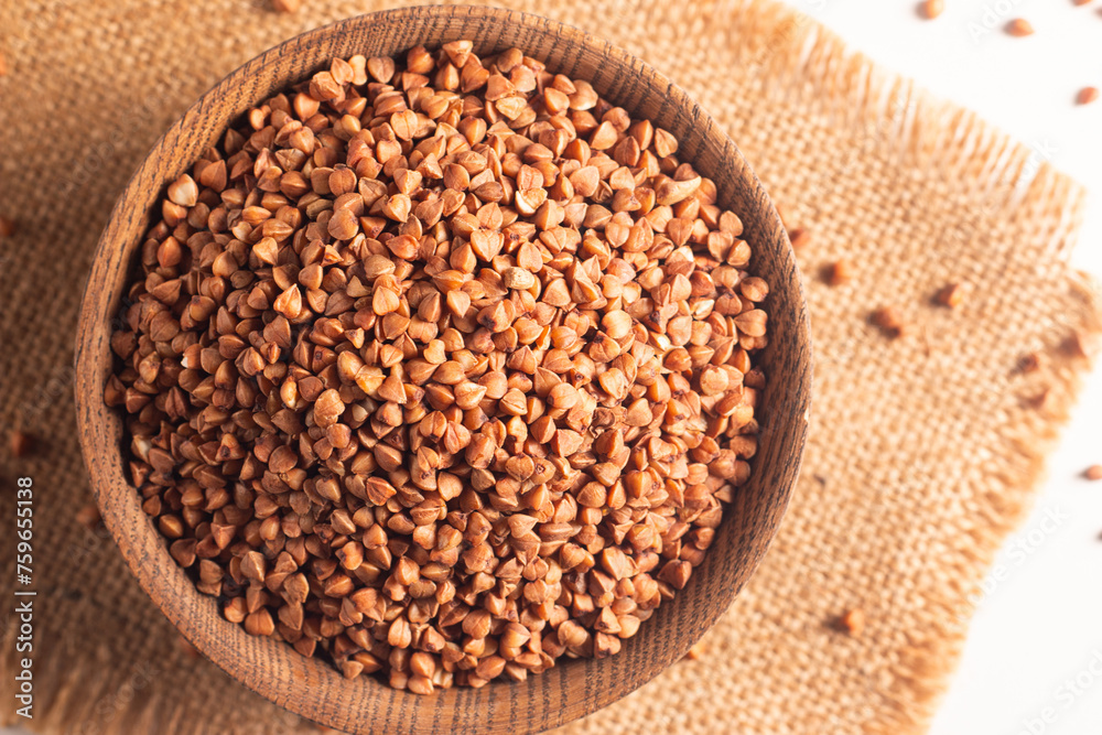 Buckwheat groats on wooden background. Healthy cereal concept. Buckwheat groats on wooden background. Healthy cereal concept.