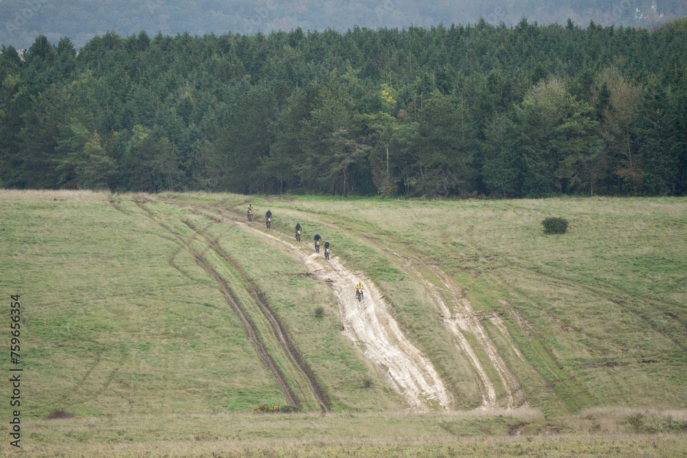 motor cyclists (bikers) riding off-road motorbikes down a stone track on Salisbury Plain, Wiltshire