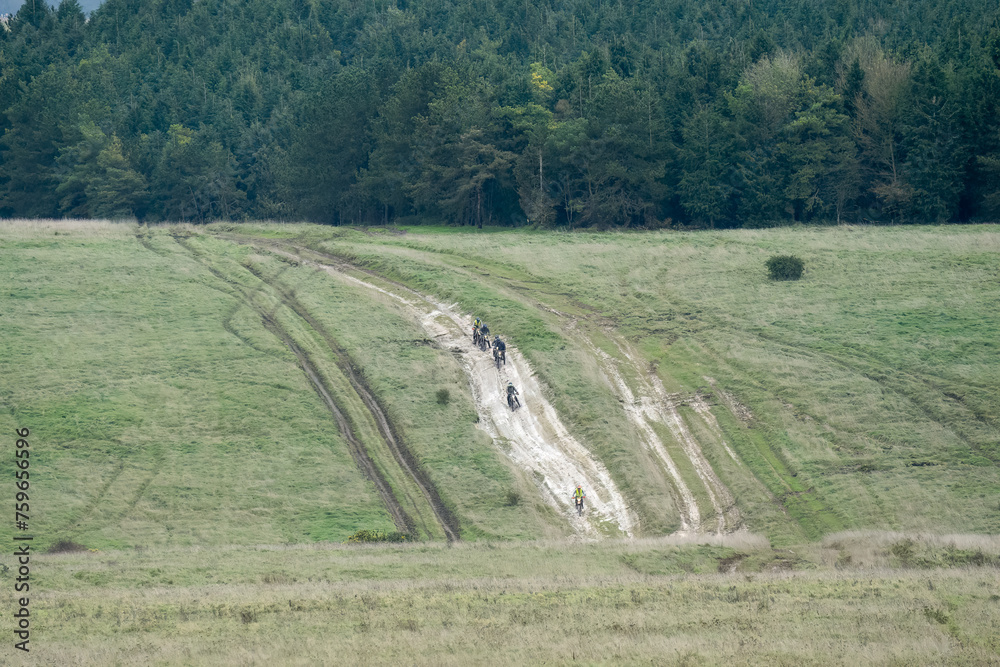 motor cyclists (bikers) riding off-road motorbikes down a stone track on Salisbury Plain, Wiltshire