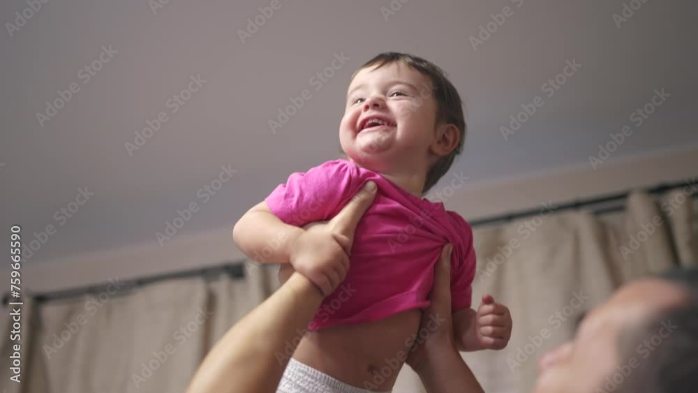 father throws a baby up indoors. happy family kid dream concept. father ...