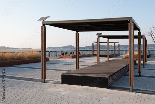 A secluded park on the beach and a chair with a roof that provides shade. 