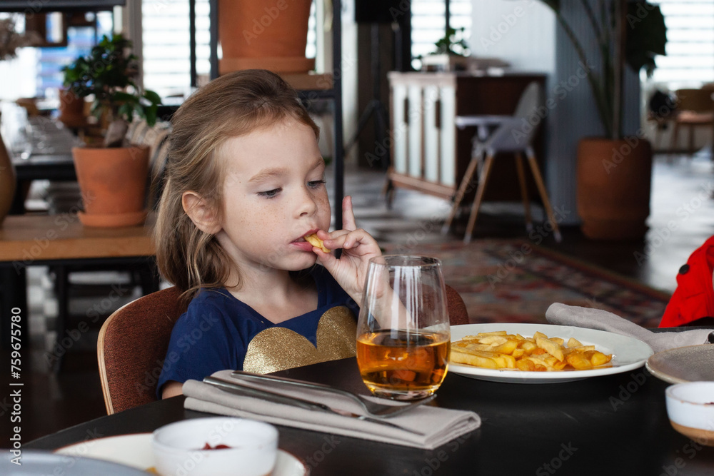 Little girl enjoying dinner at the restaurant Little girl enjoying dinner at the restaurant
