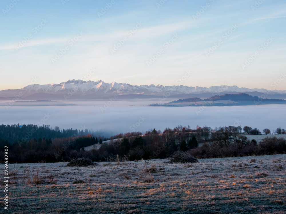 Landscape in the morning. There is fog in the valley. View of the Tatra Mountains from the Pieniny Mountain Range Landscape in the morning. There is fog in the valley. View of the Tatra Mountains from the Pieniny Mountain Range