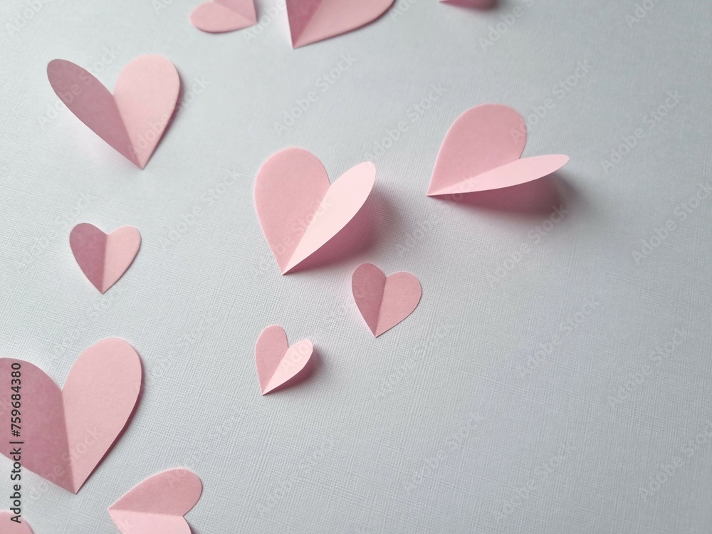Pink paper heart on white background