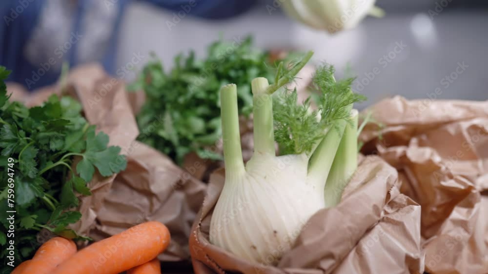 Fresh vegetables and fruits in eco-friendly paper bags from food delivery service, woman pulling out green lettuce salad out the package and putting on kitchen table, online shopping and food courier Fresh vegetables and fruits in eco-friendly paper bags from food delivery service, woman pulling out green lettuce salad out the package and putting on kitchen table, online shopping and food courier