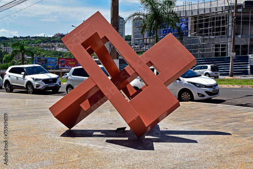 RIBEIRAO PRETO, SAO PAULO, BRAZIL - December 26, 2023: Metallic sculpture by Francisco Muñoz Junior on sidewalk photo