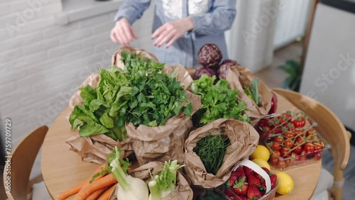 Express food delivery service, female checking ordered groceries delivered in eco paper bags, fresh vegetables and fruits from farmer's market for selling, healthy eating and online shopping concept