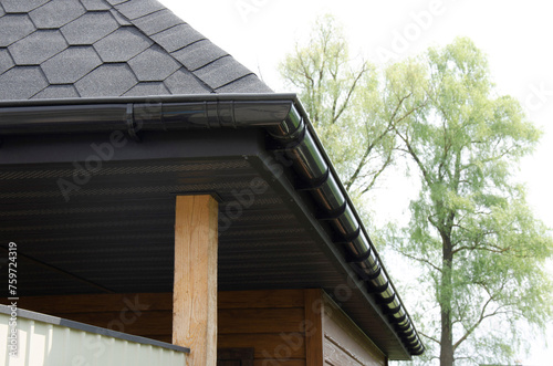 Graphite plastic gutter system on roof overhang