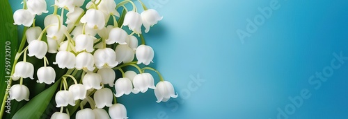 Elegant lily of the valley bouquet on a textured blue background. ideal for spring themes. serene and artistic presentation. 
