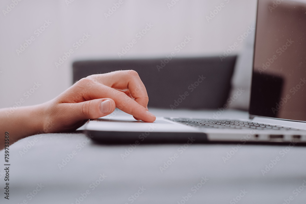 Close up of unknown young caucasian woman using laptop, female hands typing, writing notes, studying languages, distance learning concept, checking email in morning, working at home Close up of unknown young caucasian woman using laptop, female hands typing, writing notes, studying languages, distance learning concept, checking email in morning, working at home