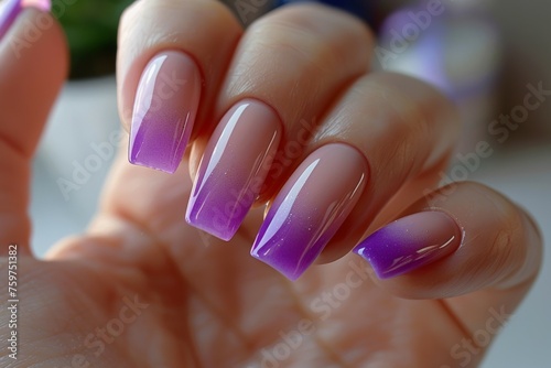 A hand with purple and pink nails