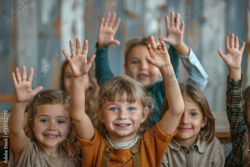 A group of children are smiling and waving at the camera