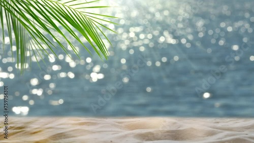 fresh green palm leaf and white sand on blurred glittering bokeh light water background, beautiful idyllic sand beach backdrop with product display for summer vacation, travel and relaxation outdoors photo
