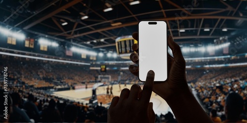 Black African-American man using smartphone during a game on basketball arena