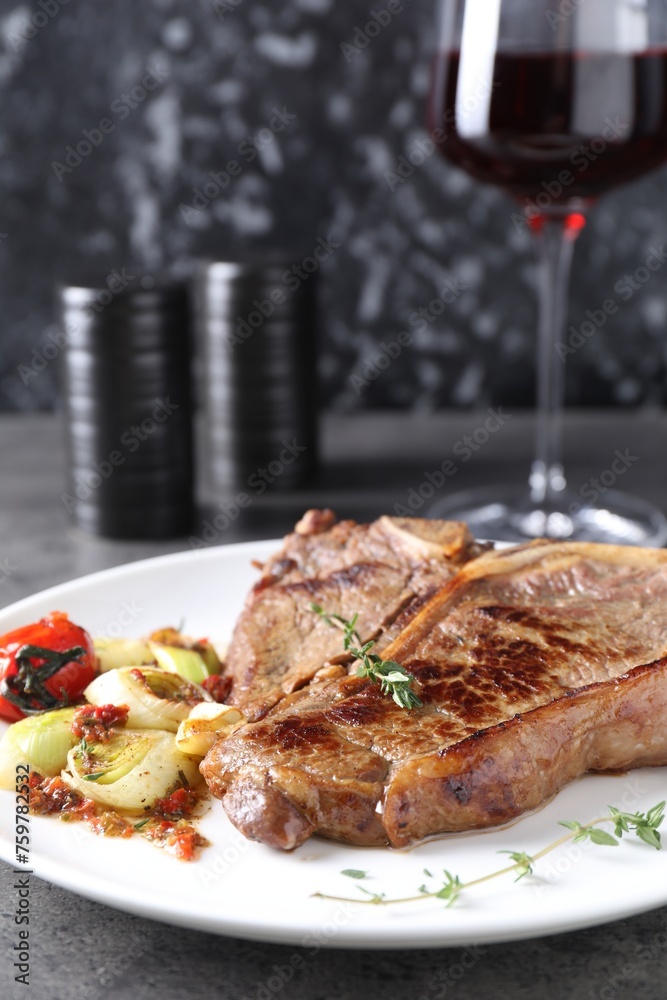 Delicious fried beef meat and vegetables on grey table Delicious fried beef meat and vegetables on grey table