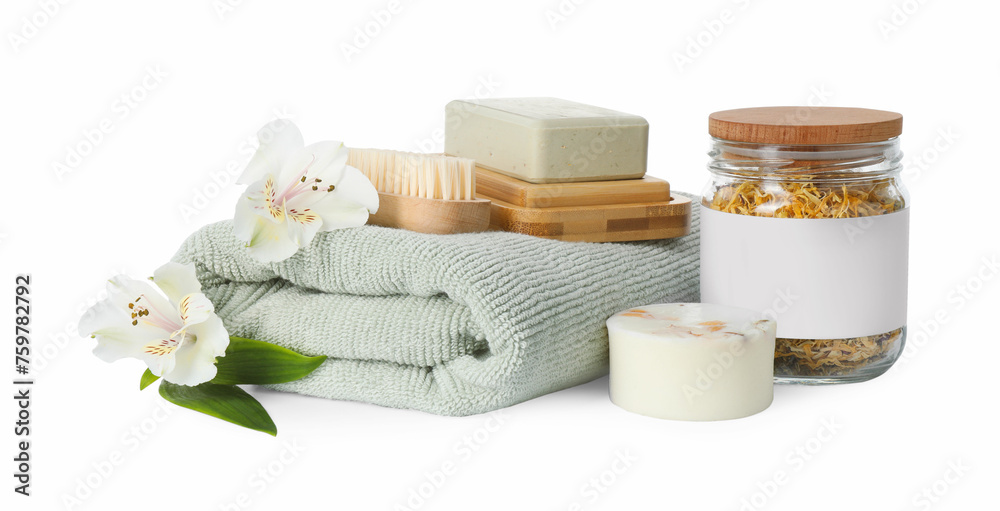 Spa composition. Towel, personal care products, brush, fresh and dry flowers on white background Spa composition. Towel, personal care products, brush, fresh and dry flowers on white background