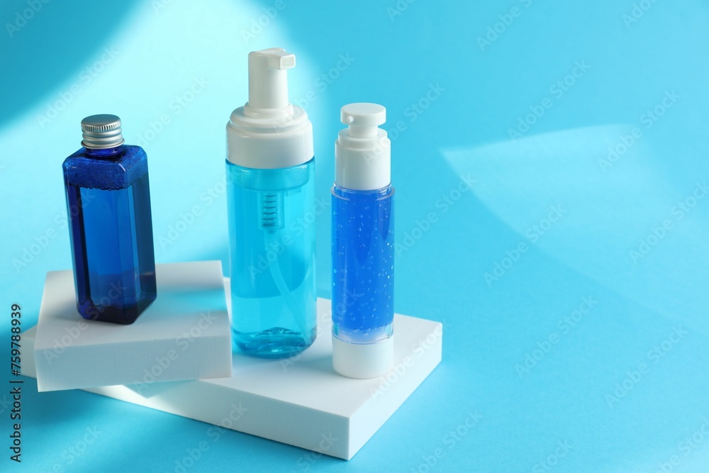 Set of luxury cosmetic products on light blue background. Space for text Set of luxury cosmetic products on light blue background. Space for text